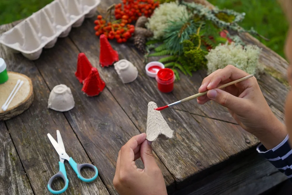 Colorful craft supplies like yarn, scissors, glue and paper